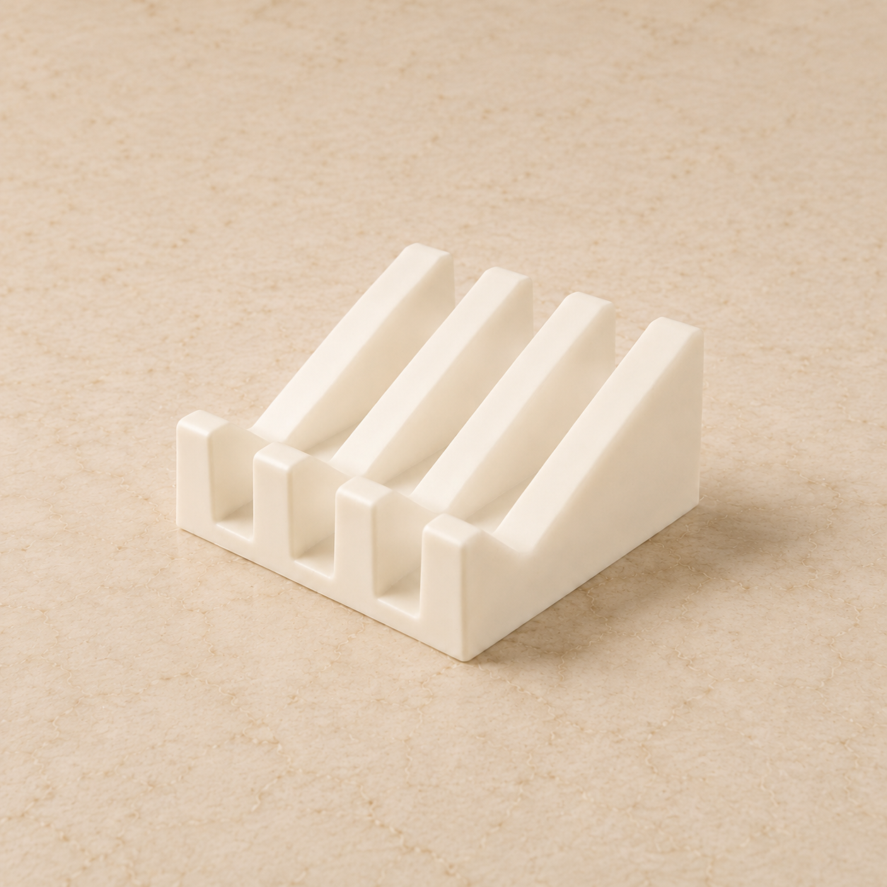 Ivory ridged soap dish shown alone on a warm beige stone countertop with soft natural lighting.