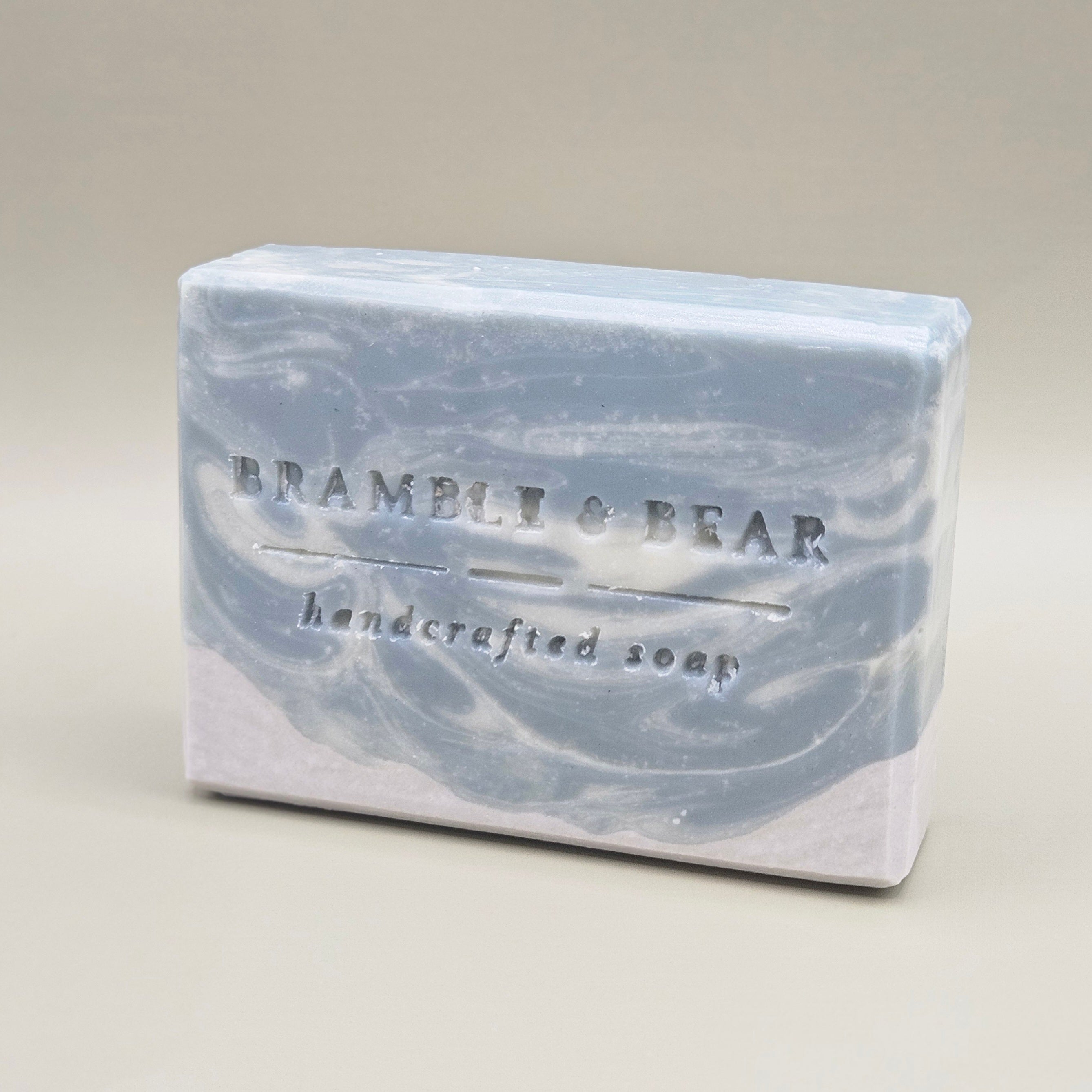 A bar of Northern Fjord Air soap facing left against a plain gray background.