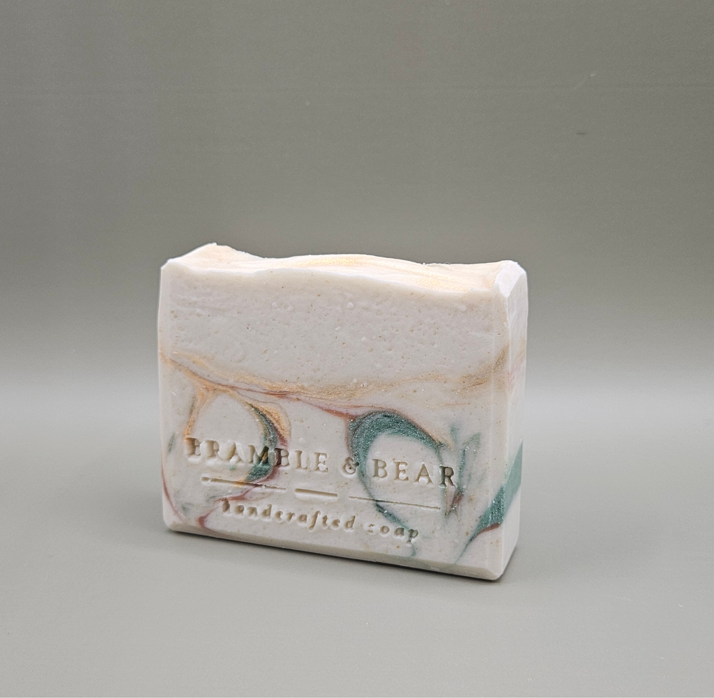 Sunlit Citrus Grove soap bar facing left against a plain gray background.