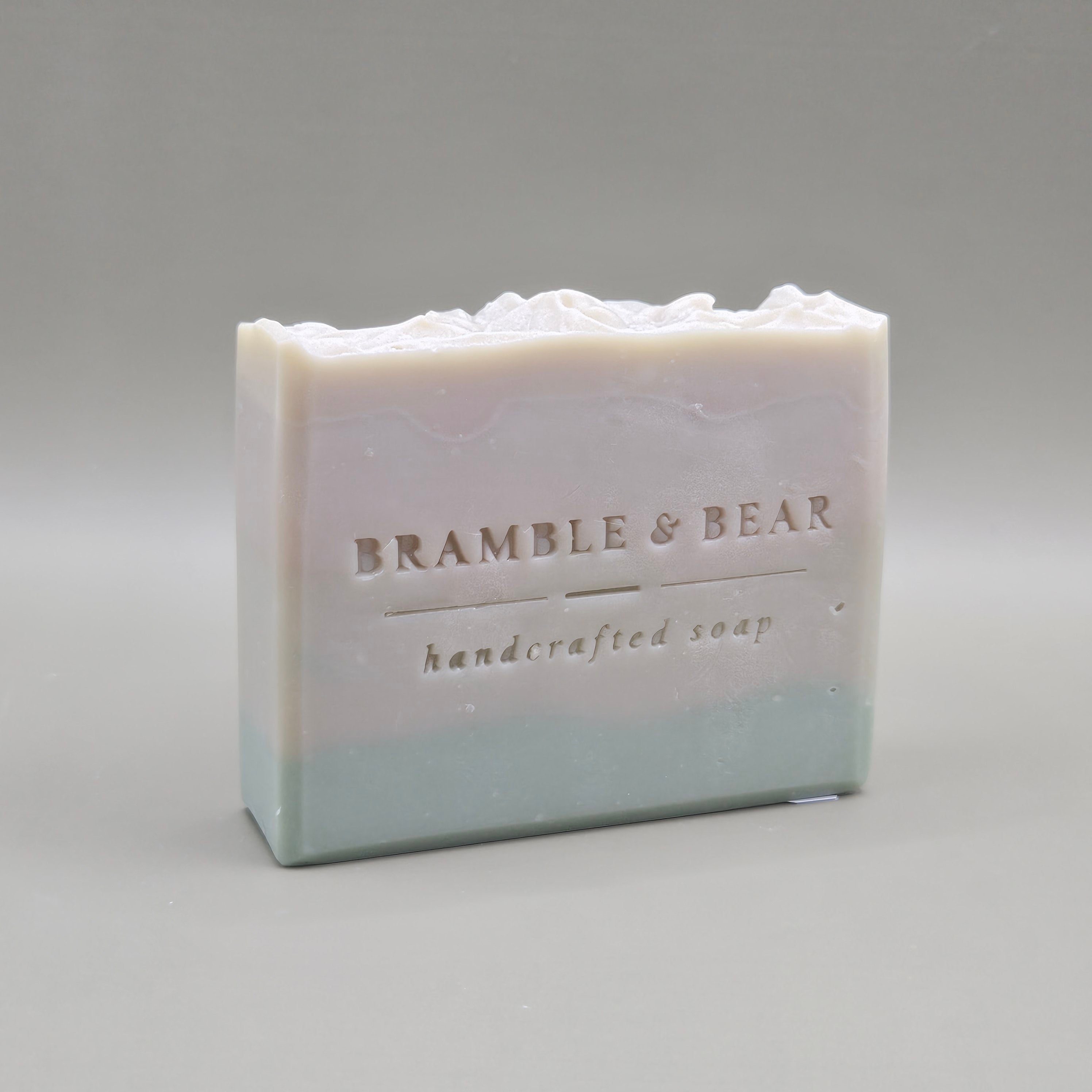 Juniper Amber Sky soap bar facing right against a plain gray background.
