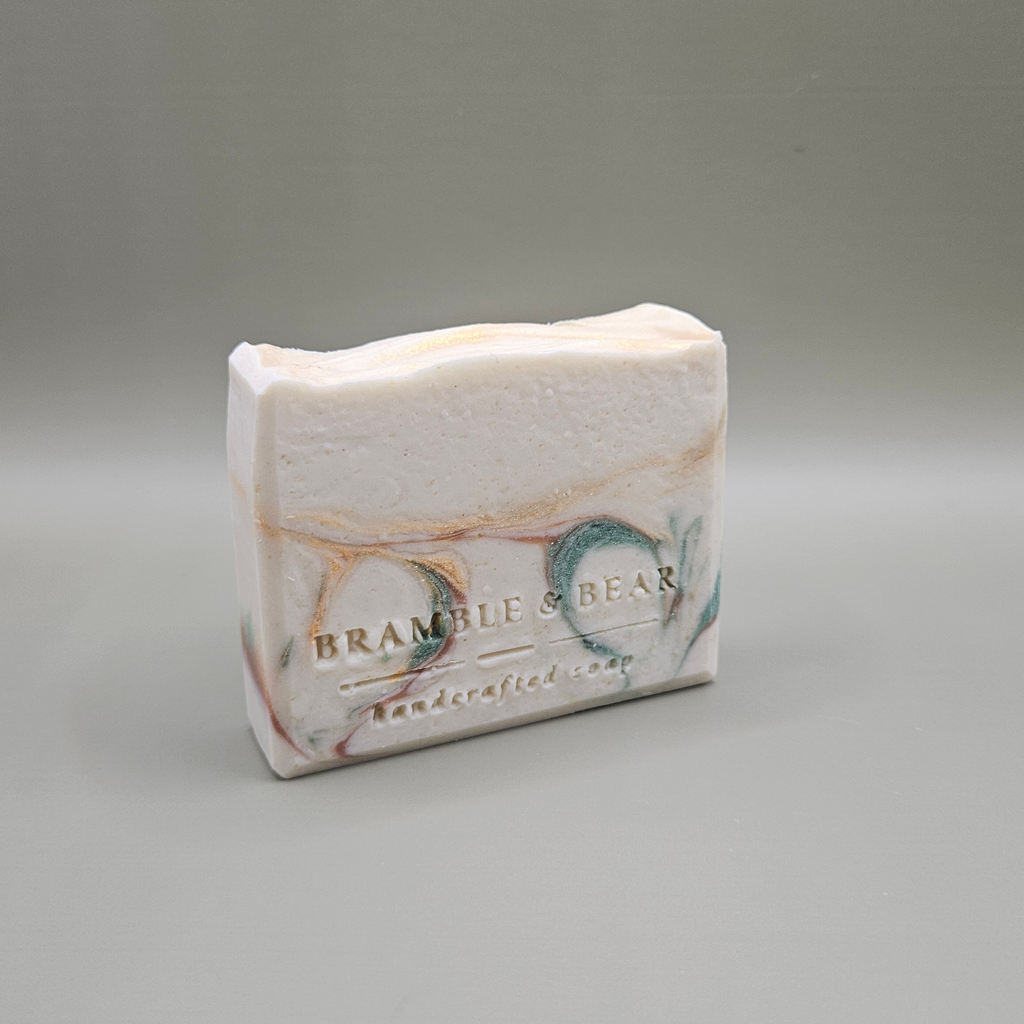 Sunlit Citrus Grove soap bar facing right against a plain gray background.