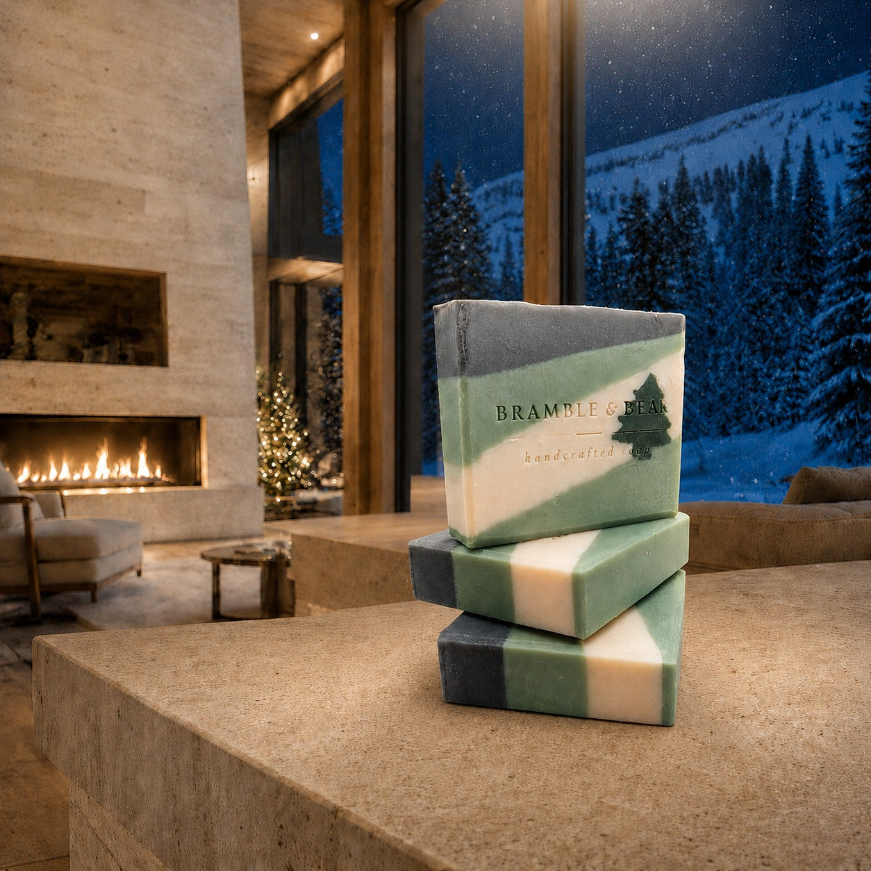 Stacked Bramble & Bear Silent Evergreen Night soap bars on a stone counter in Aspen, with a fireplace and snowy forest beyond the windows.