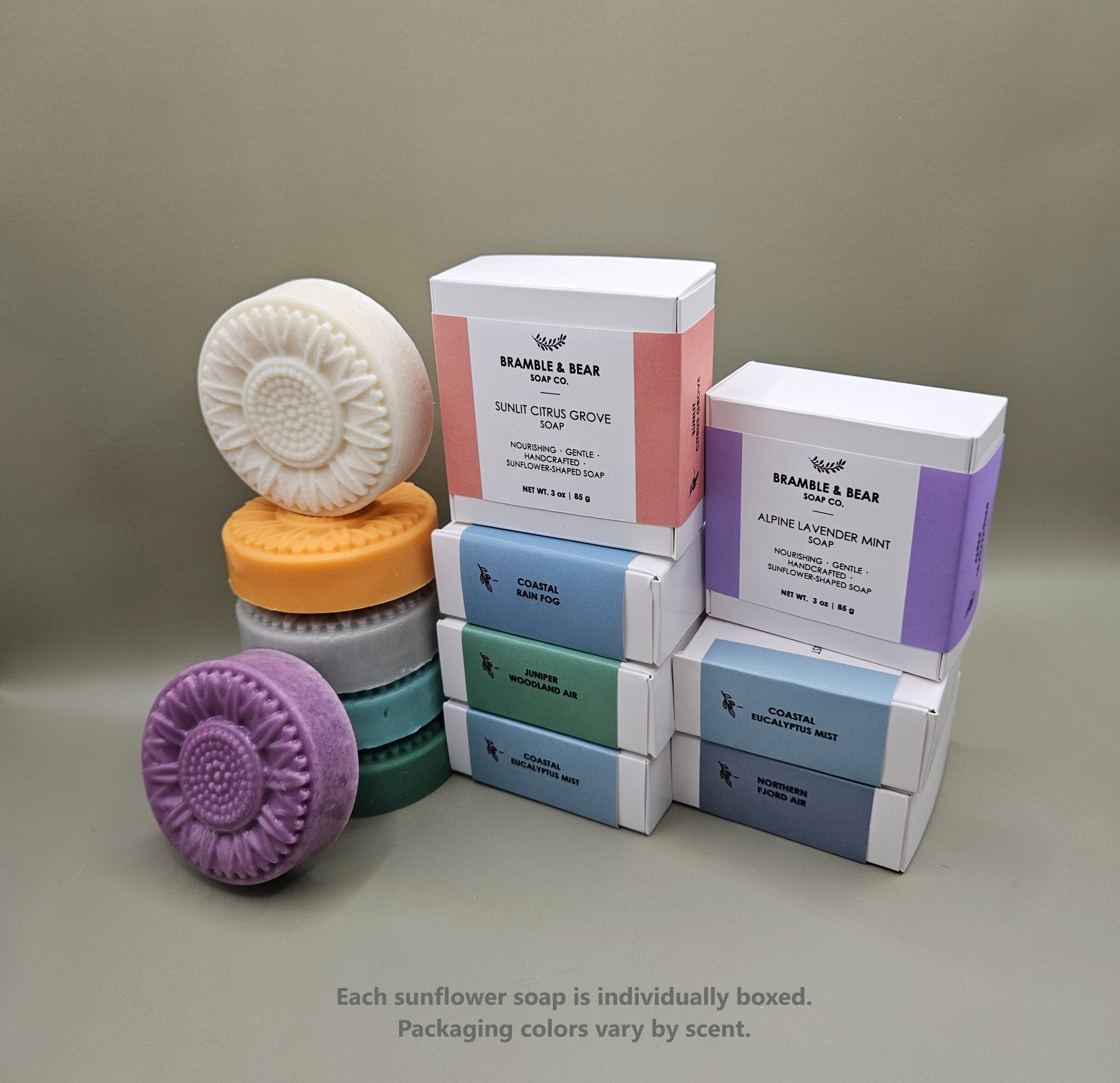 Bramble & Bear sunflower-shaped soaps shown with individual boxed packaging in soft pastel colors.